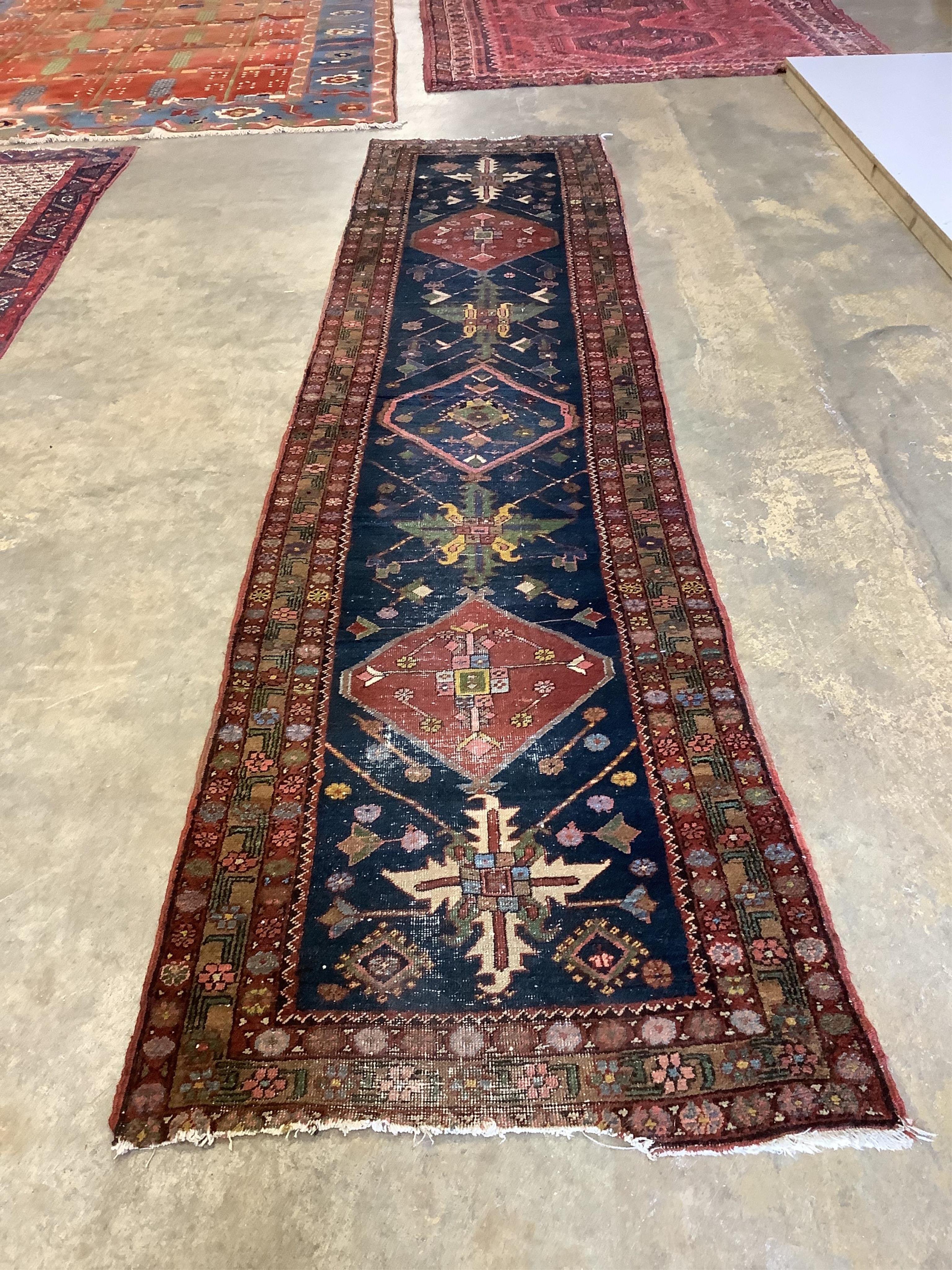 A Persian blue ground runner, 380 x 85cm. Condition - some wear and dog odour, worn at the fringes